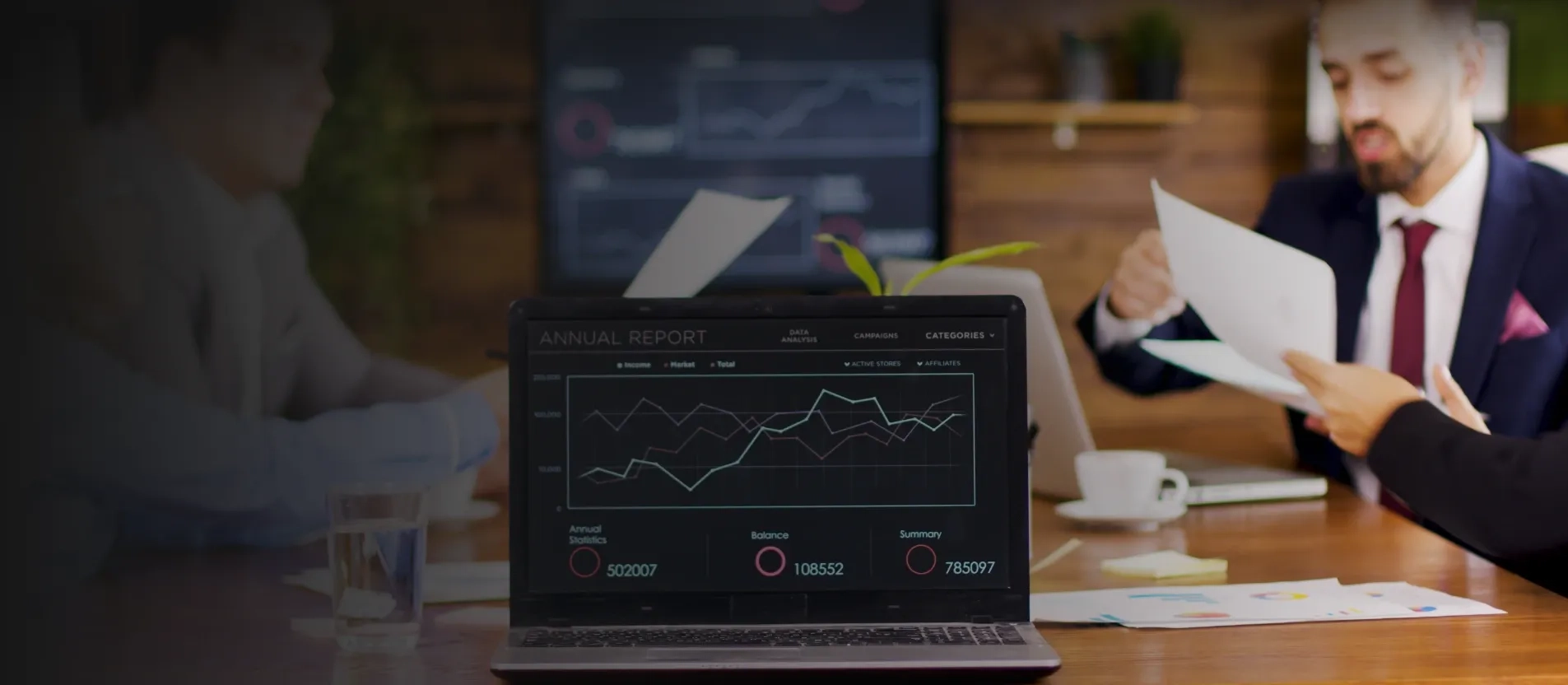 A Laptop with Asset Management Software displaying charts in the conference room 