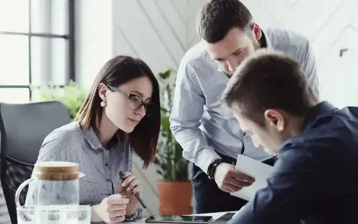 Corporate employees discussing the implication of the FM system to their facility