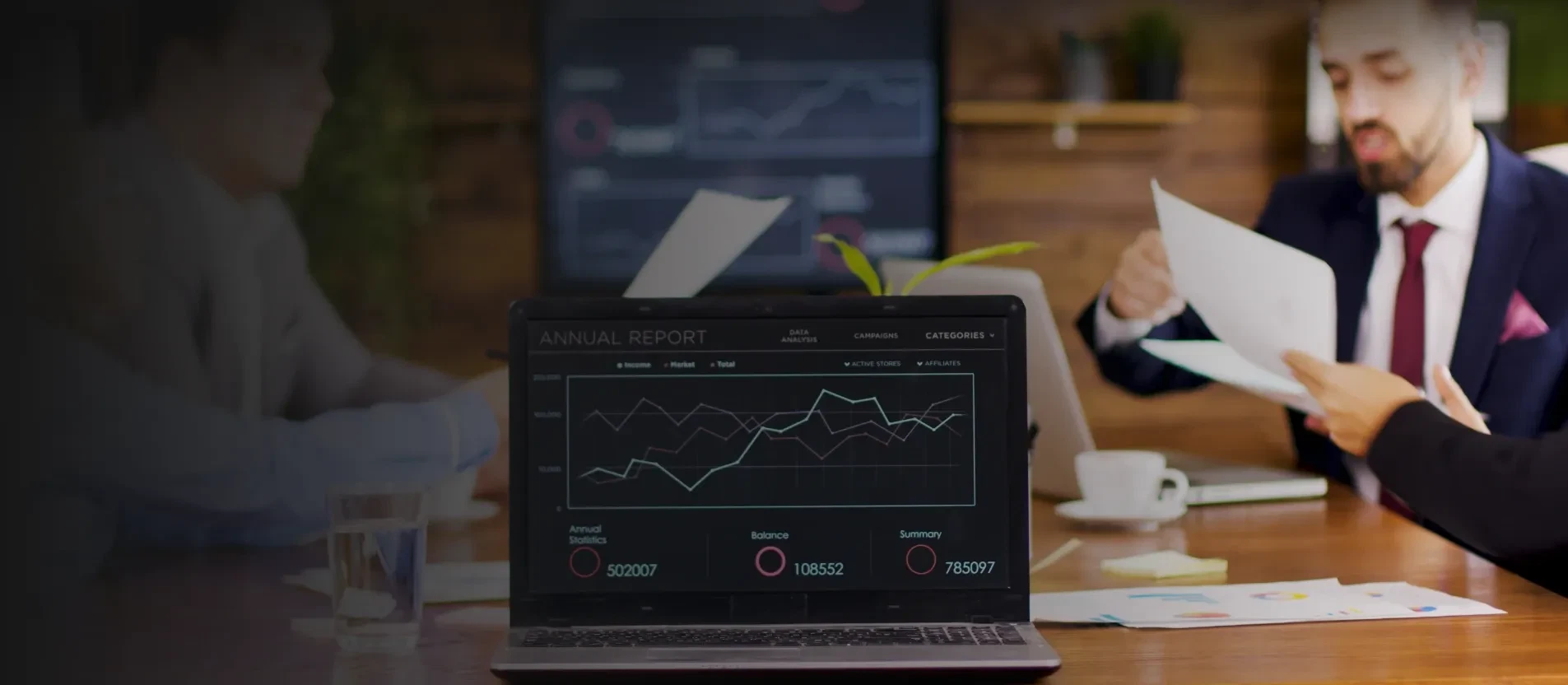 A Laptop with Asset Management Software displaying charts in the conference room 