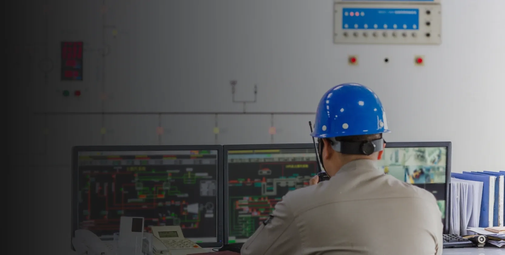 Worker using facility management system to monitor equipment and assets.
