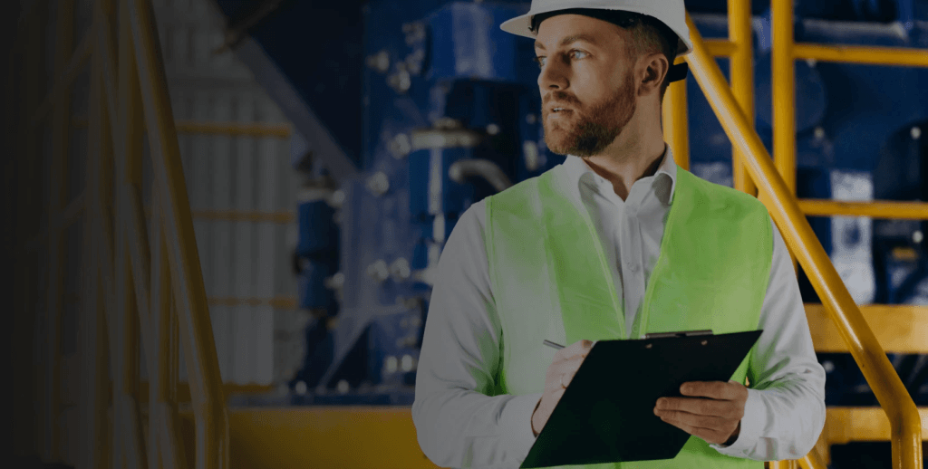 Facility manager taking notes before using predictive maintenance strategy.
