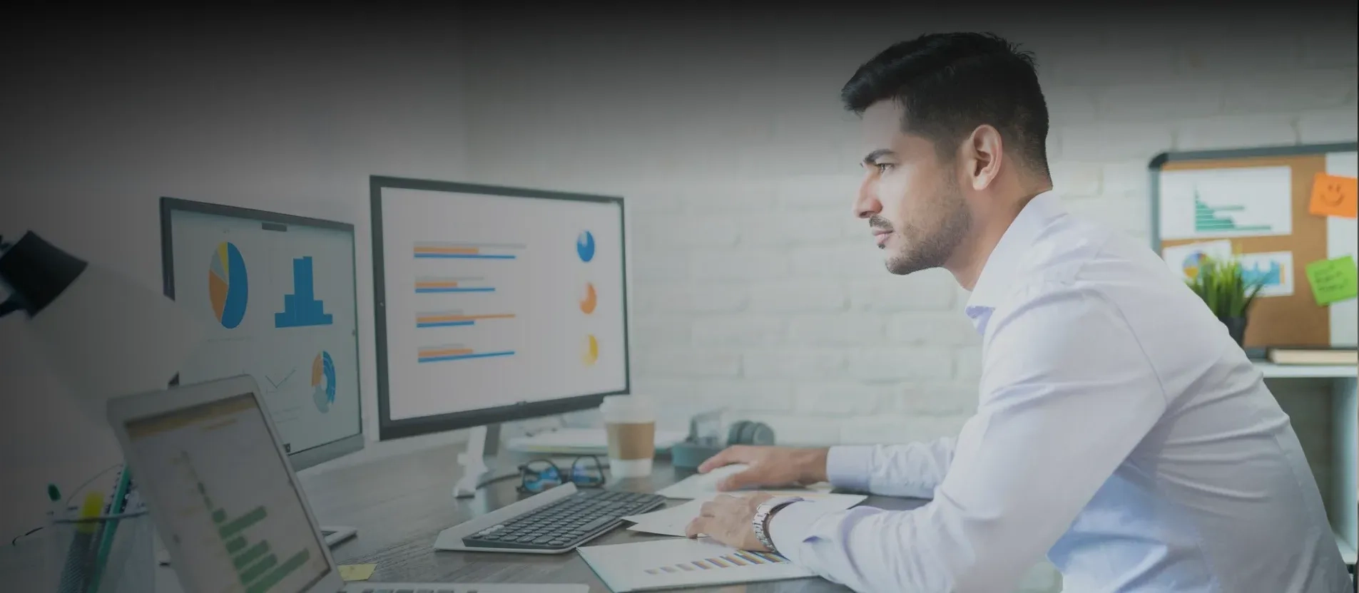 Man using IoT remote monitoring system to track the daily operations in facility